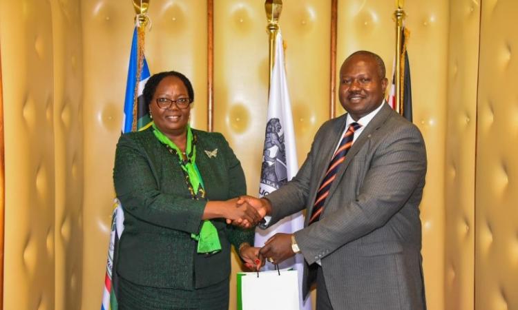 The Principal Administrative Secretary for The ministry of Interior and National Administration Ann Ng'etich who chaired the meeting receives a gift hamper from her host, NACADA CEO Dr. Anthony Omerikwa, MBS  